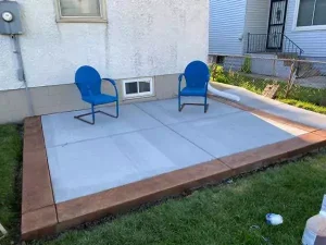 Decorative concrete patio with blue chairs