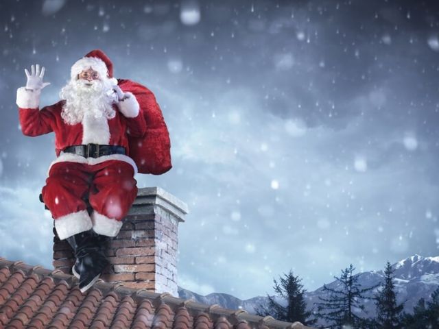 santa sitting on brick chimney