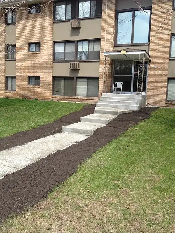 Concrete sidewalk in front of an apartment building