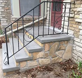 Masonry concrete steps leading to entry door